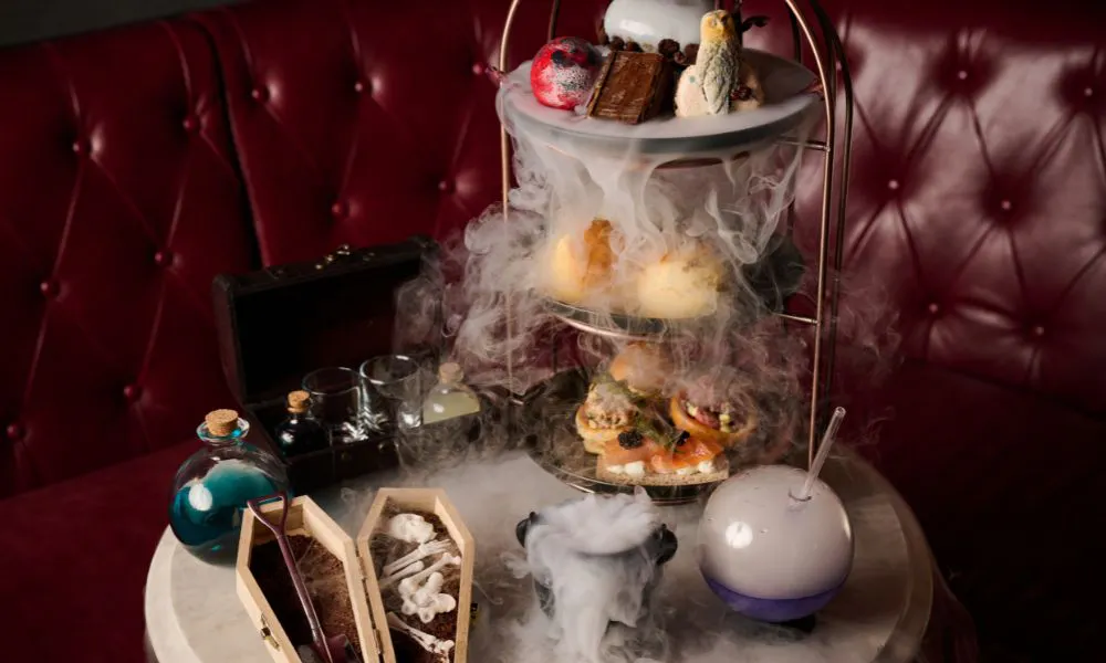 afternoon tea stand with dry ice and magic-inspired scones and sarnies