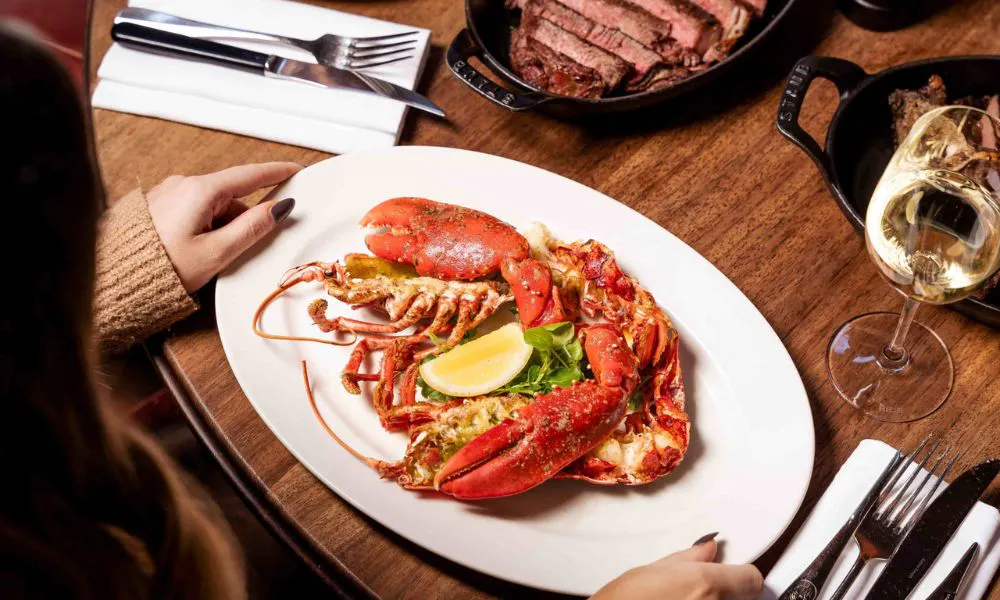 Lobster with claws and lemon wedge