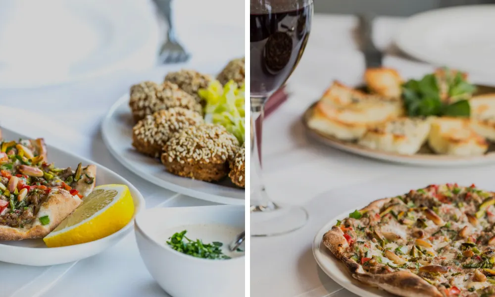 glass of red wine and bright plates at Ishbilia