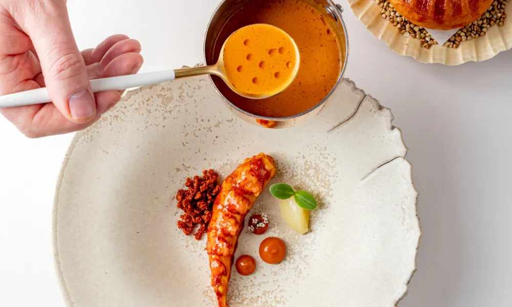 lobster tail with bright orange sauce