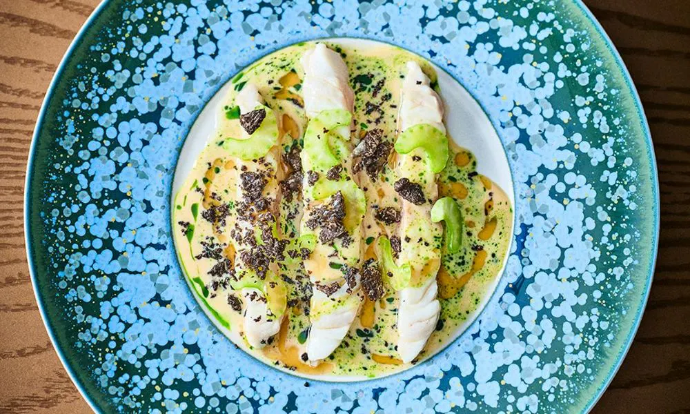 Beautiful fish dish on blue plate