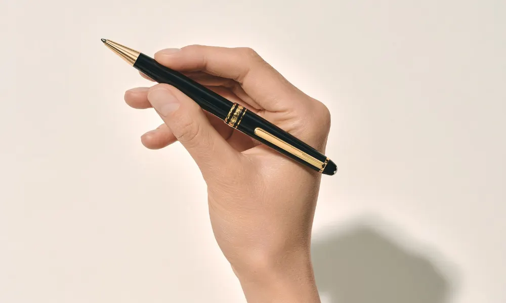 Hand holding a Montblanc ballpoint pen gift