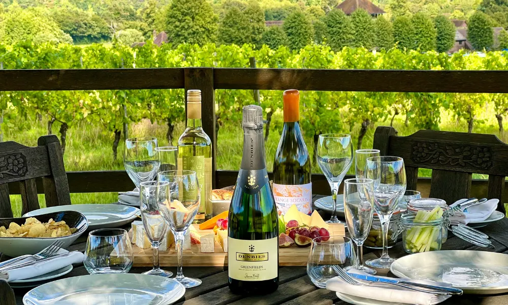 bottle of wine with cheeseboard at Denbies vineyard