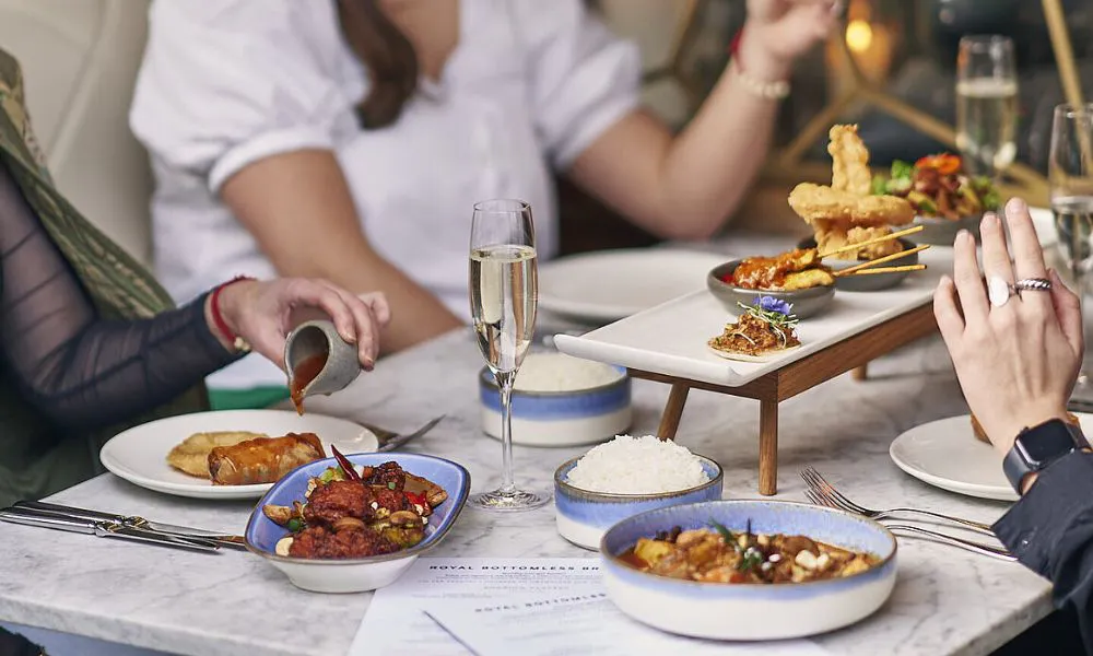 Thai sharing platters and glasses of Prosecco