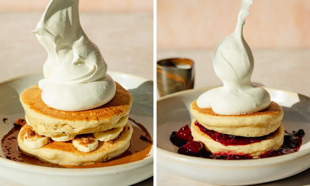 thick pancakes with whipped cream and fruit