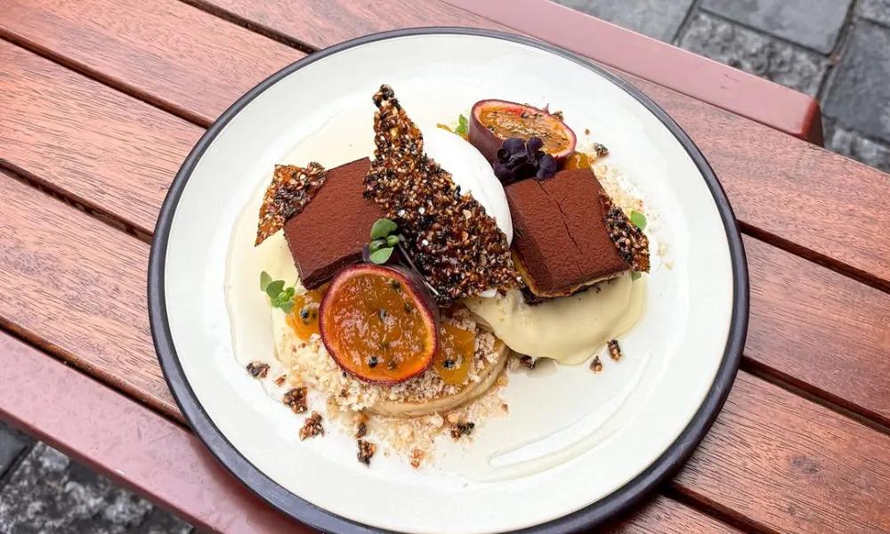 two pancakes with meringue, grapefruit and chocolate