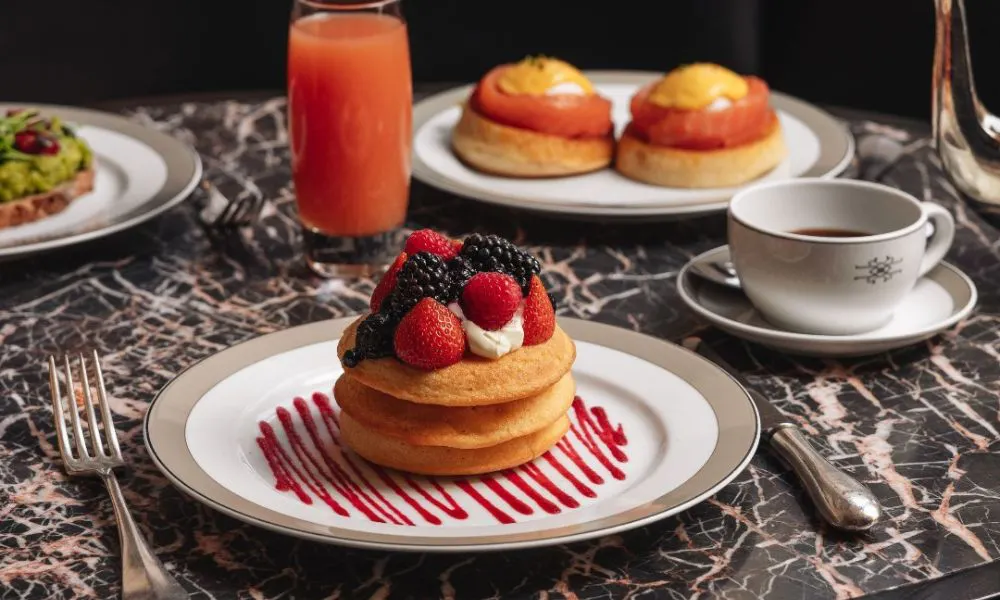 neat plate of pancakes with blackberries and raspberries