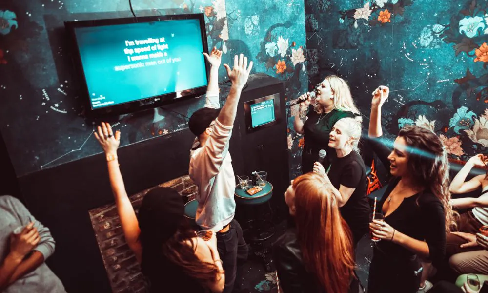a group of people singing karaoke