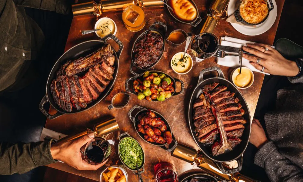 Hawksmoor festive table with steak and sides