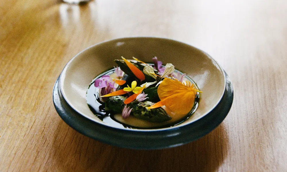 bowl with colourful food and edible flowers