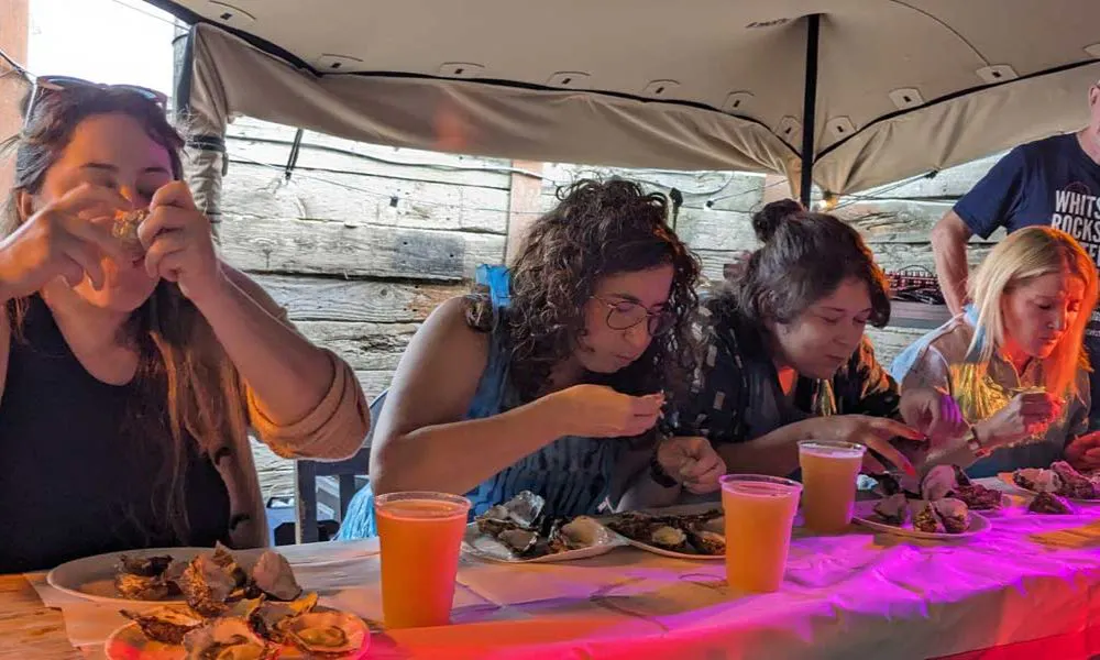 a group of people eating oysters