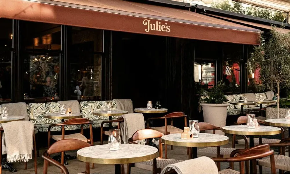 exterior of a french restaurant with outdoor bistro seating