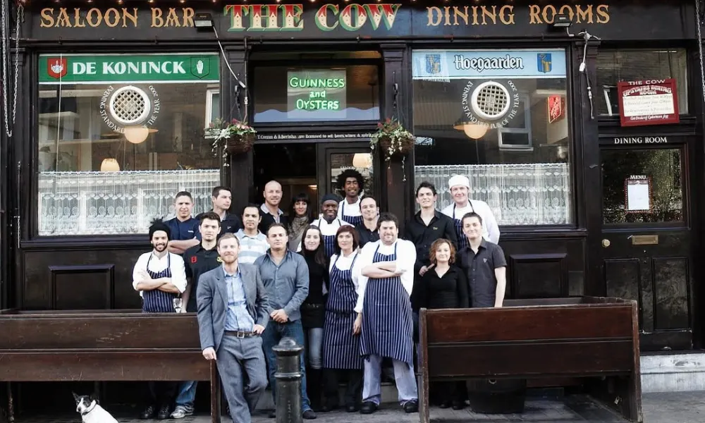 team picture outside The Cow pub