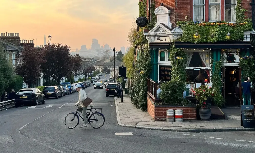 Ivy-clad pub on a hill with london skyline in background