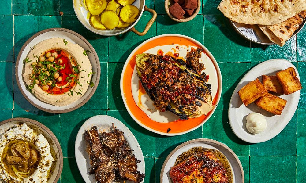 A spread of Middle Eastern dips, grilled vegetables and potatoes