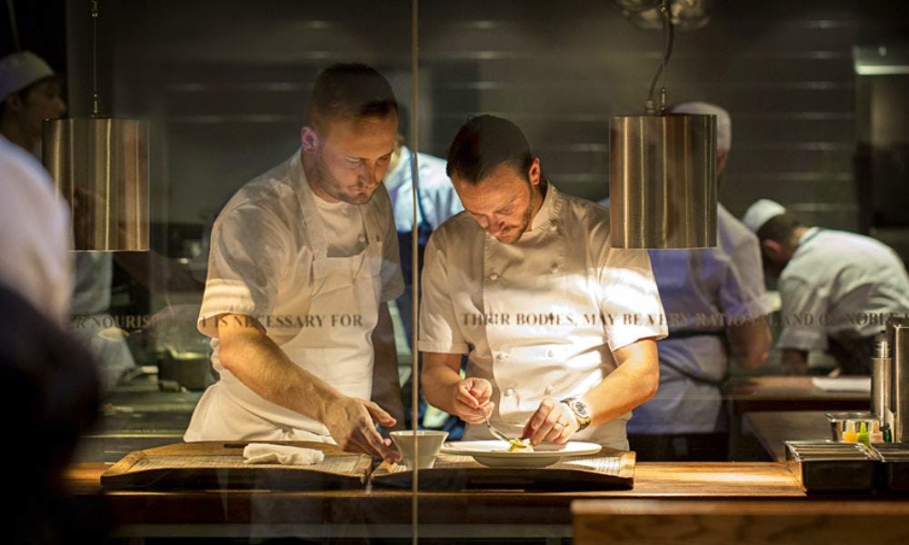 Two chefs working together in an open kitchen