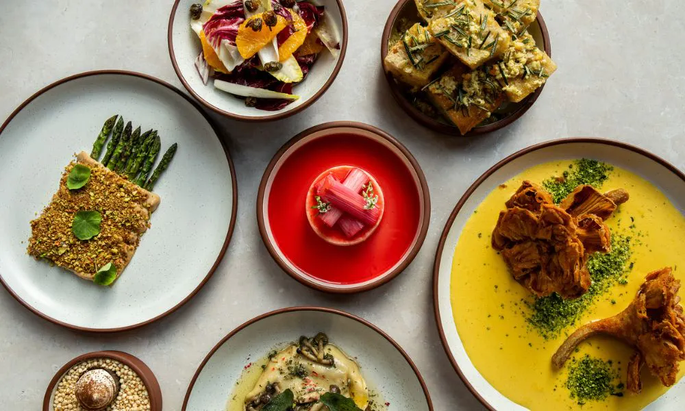 Colourful plates, curry and dessert laid on a table