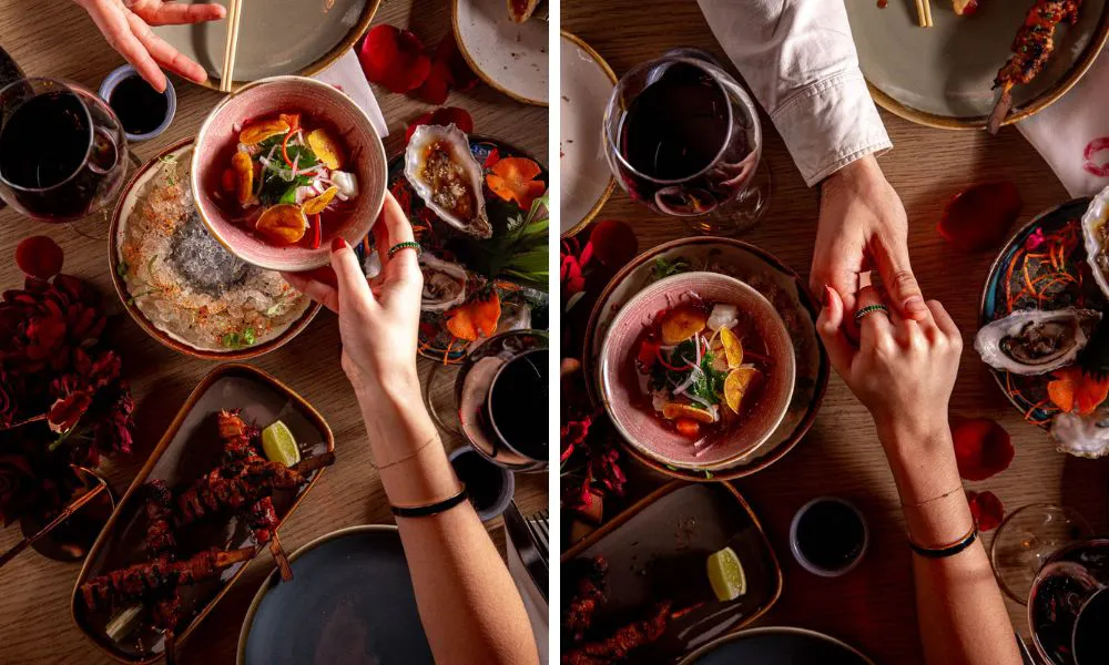 table with colourful dishes and couple holding hands