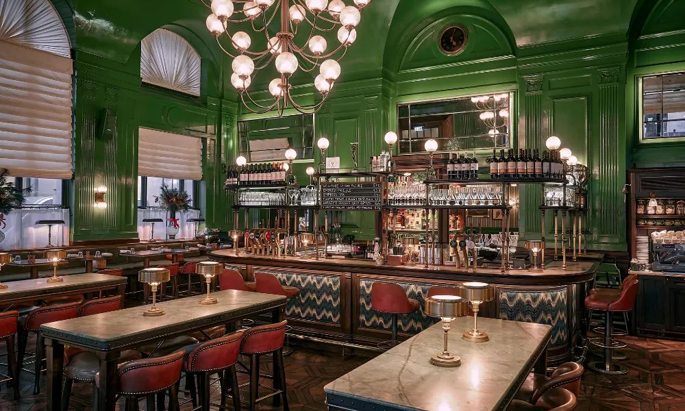 Green pub with bar and high top tables