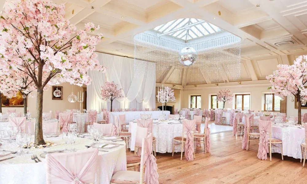 reception hall with dance floor, disco ball, and pink trees