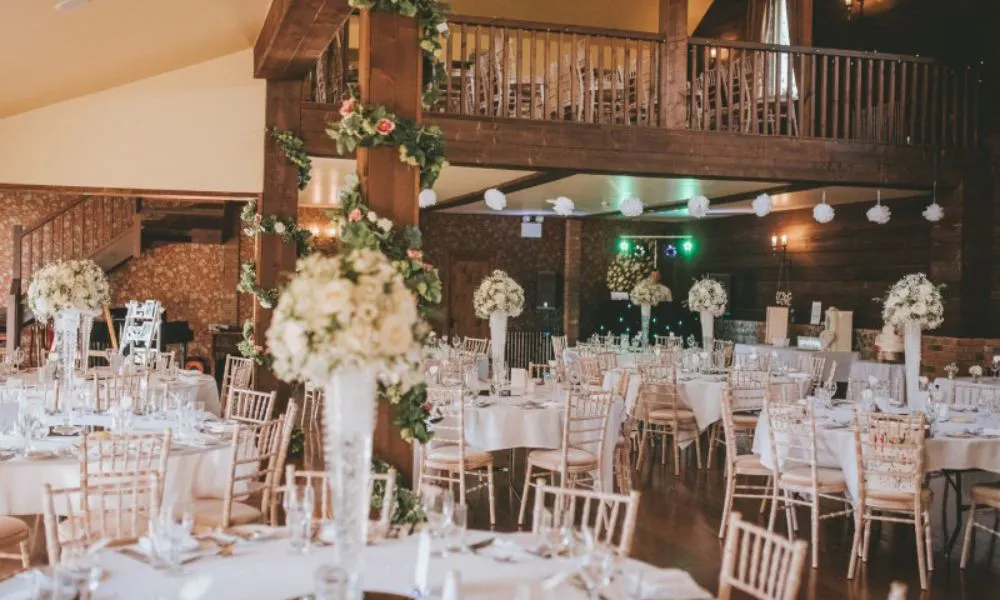 two level wedding barn with white tables and flowers