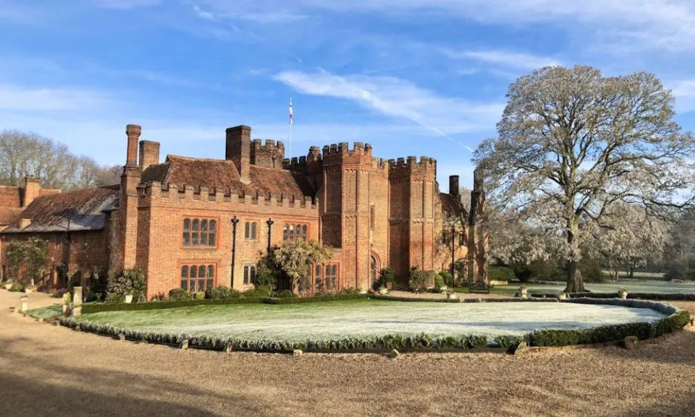 Tudor priory with turrets, flag and lawn