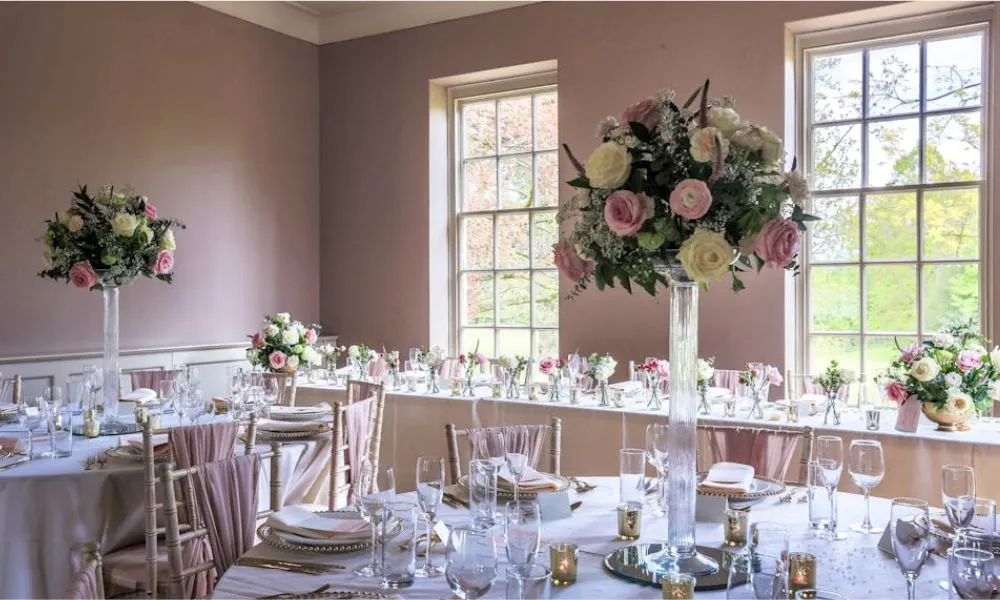 pink room with wedding tables and rose centrepieces