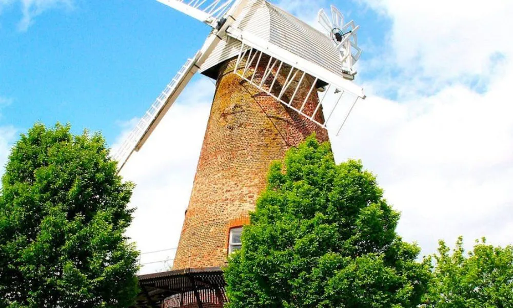 Brick windmill with platform and trees