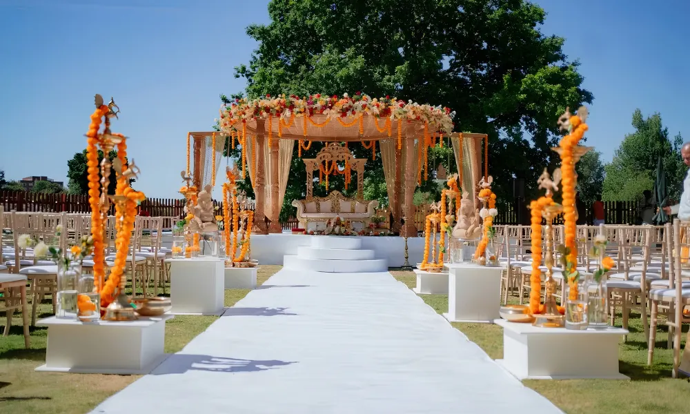 Orange flower filled arbour set up for ceremony
