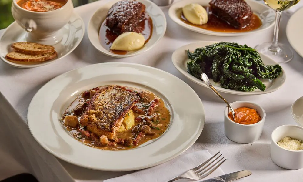 dinner table with toffee pudding and pan roasted fish
