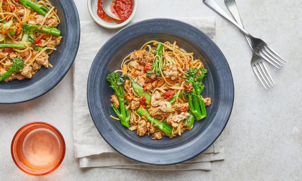 noodles with brocoli and tofu in black bowl
