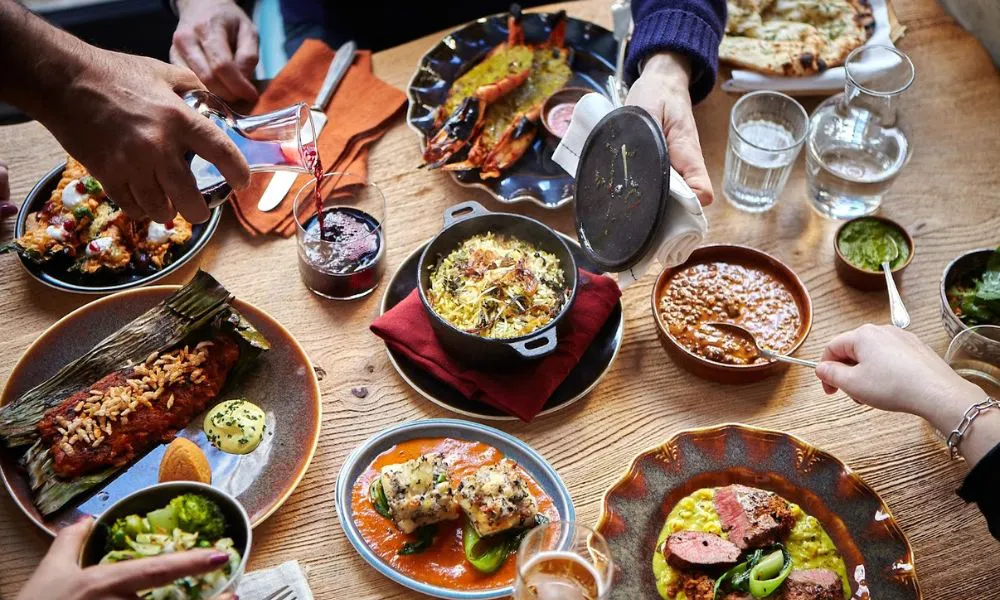indian sharing plates with rice curries and vegetable dishes