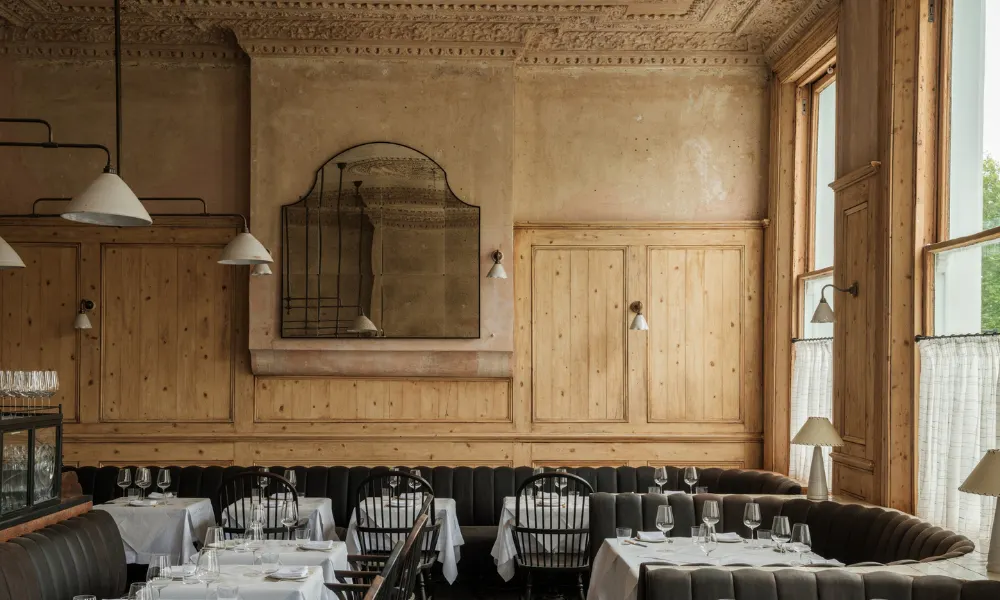 wood panelled dining room with white tables