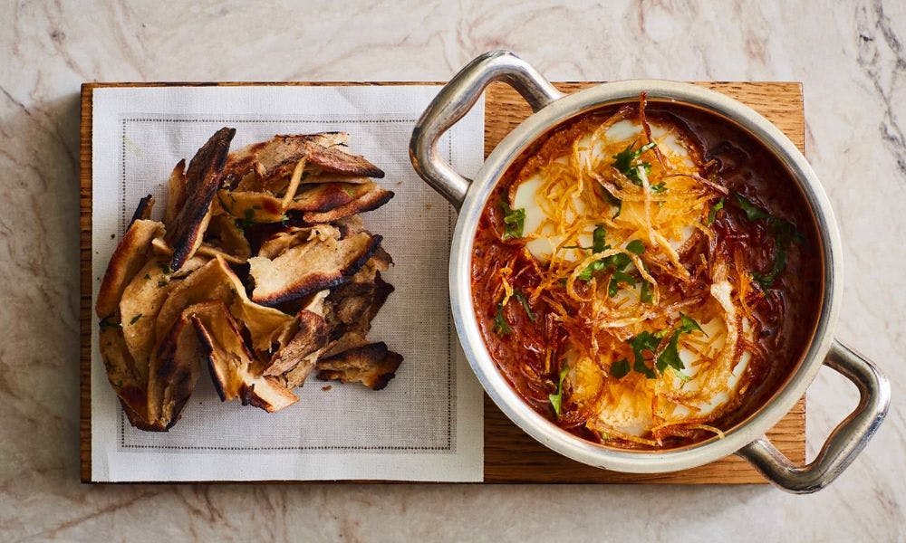 Curry in a bowl on a board
