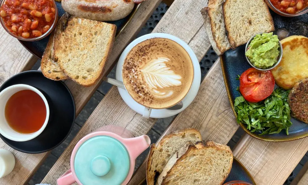 a selection of brunch dishes and coffees on a table