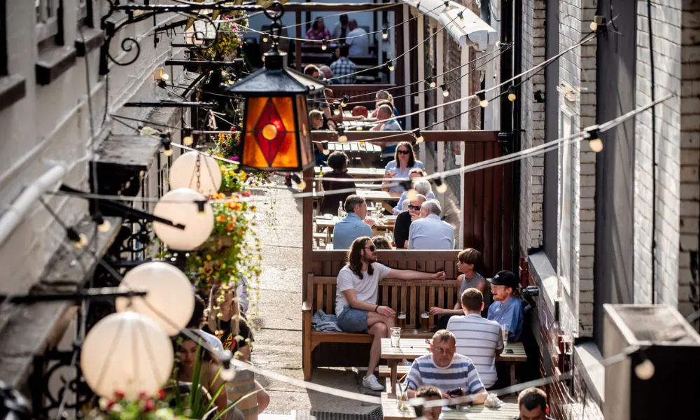 busy alley beer garden with string lights