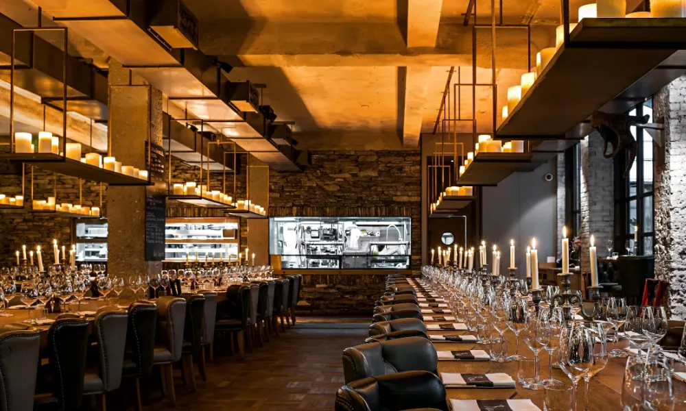 massive candlelit restaurant with very long tables