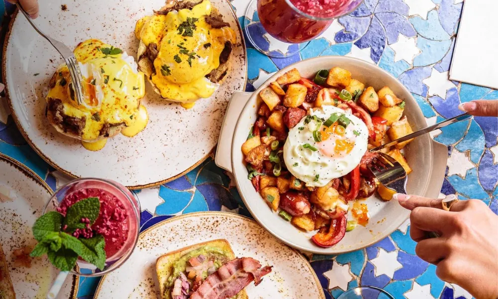 A chorizo hash with potatoes, a fried egg and spring onion 