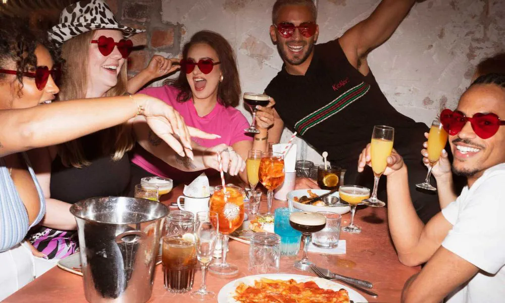 A group of people celebrating over bottomless brunch