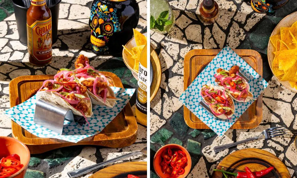 A table covered with a selection of tacos, nachos and beers