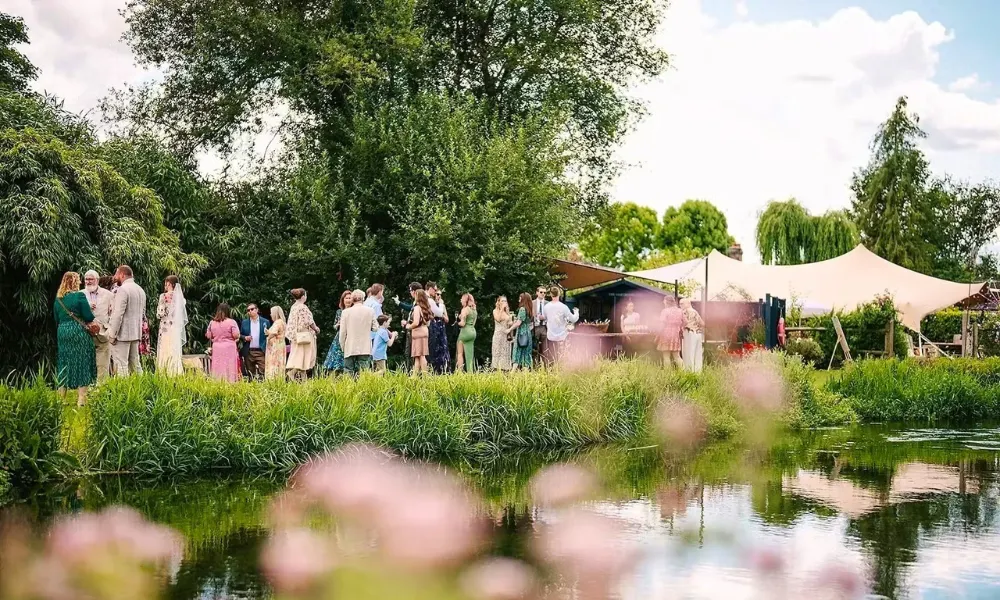 wedding reception party standing by a river