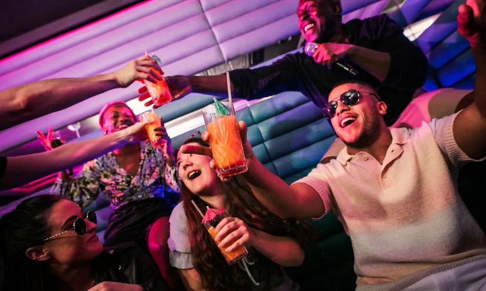 young people in purple rooms with cocktails