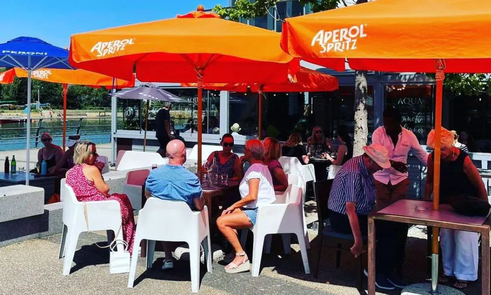 People eating under parasols
