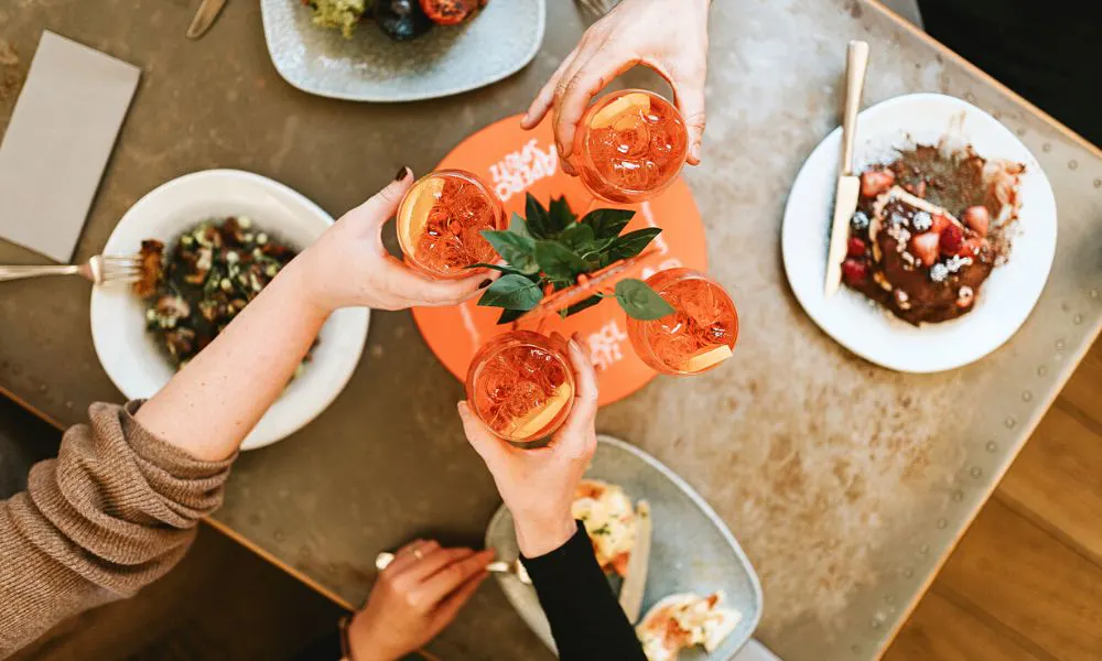 Cocktails cheersing over table