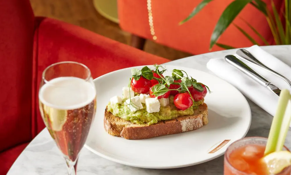 a glass of prosecco served with avocado toast