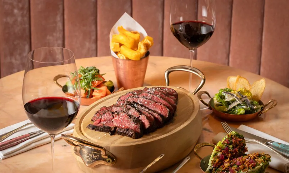 steak with chips salads and two glasses of red wine
