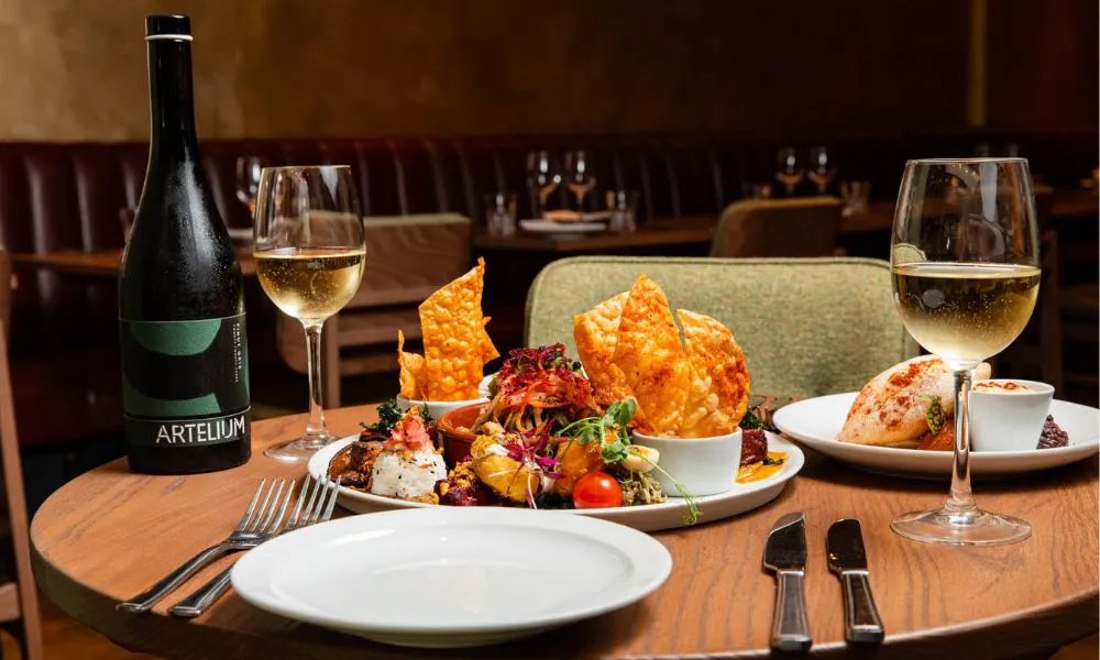 vegan snacks and a bottle of wine on a table