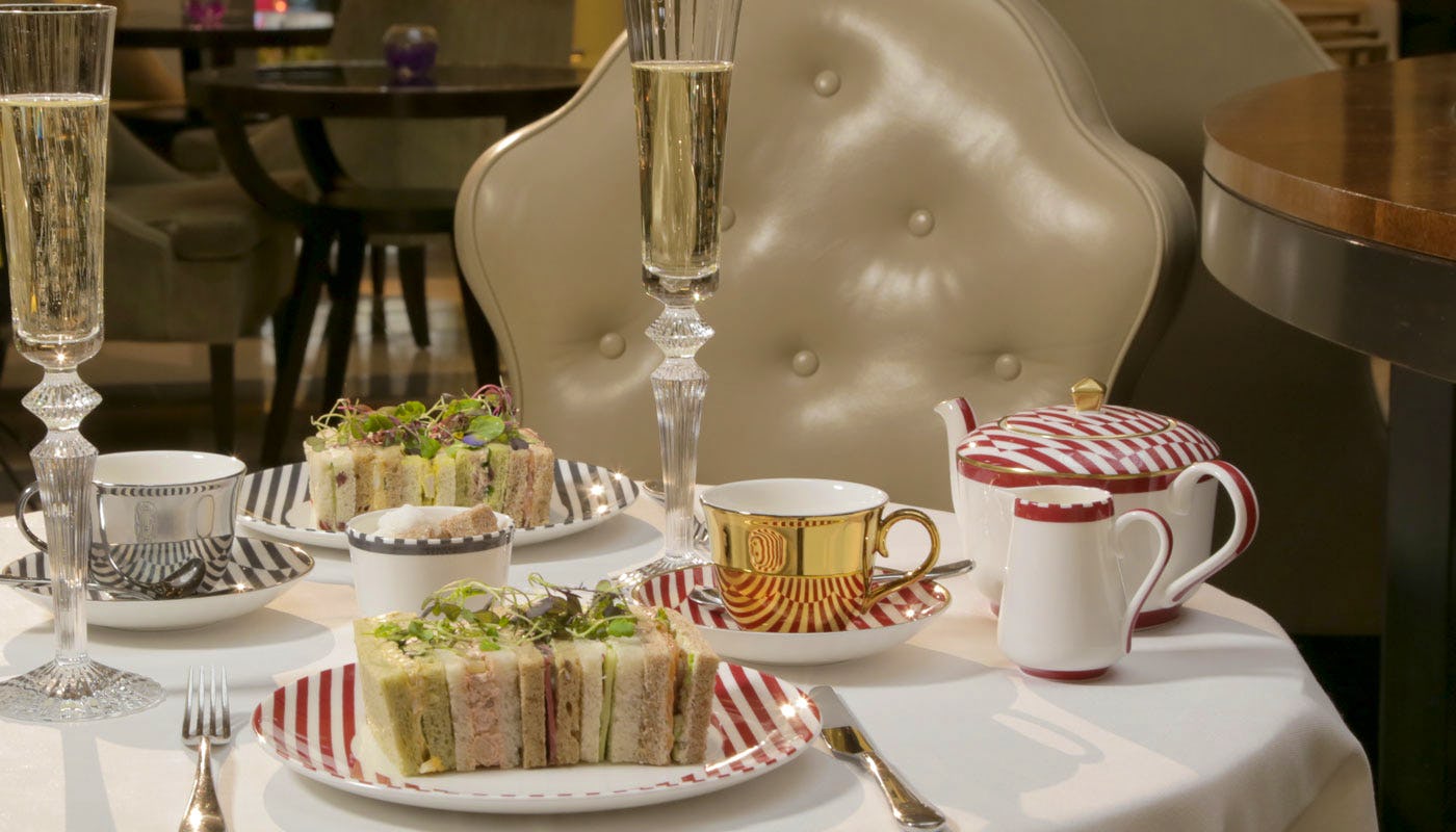 Corinthis Hotel afternoon tea sandwiches and Champagne on table