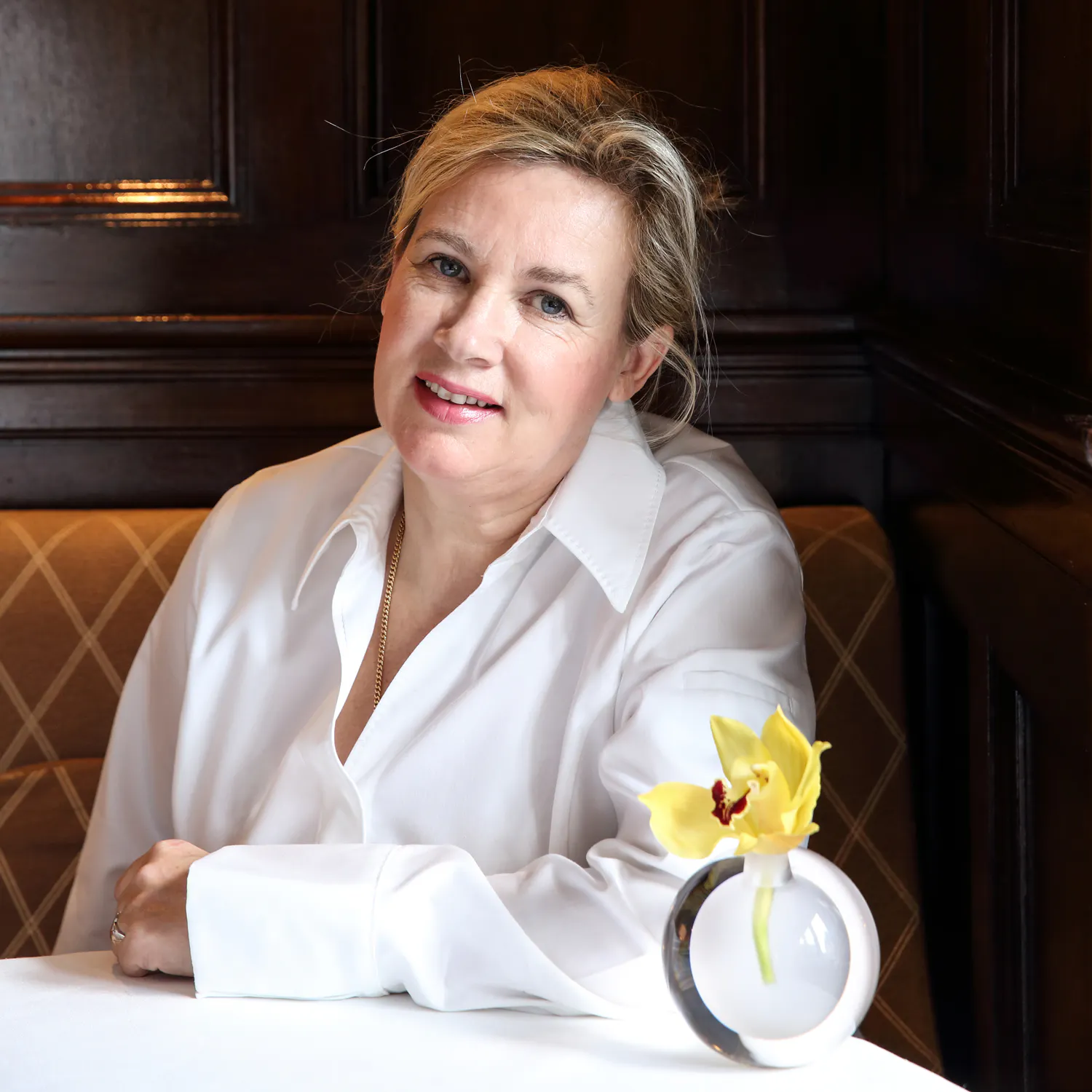 Helene Darroze chef in restaurant with floral arrangement