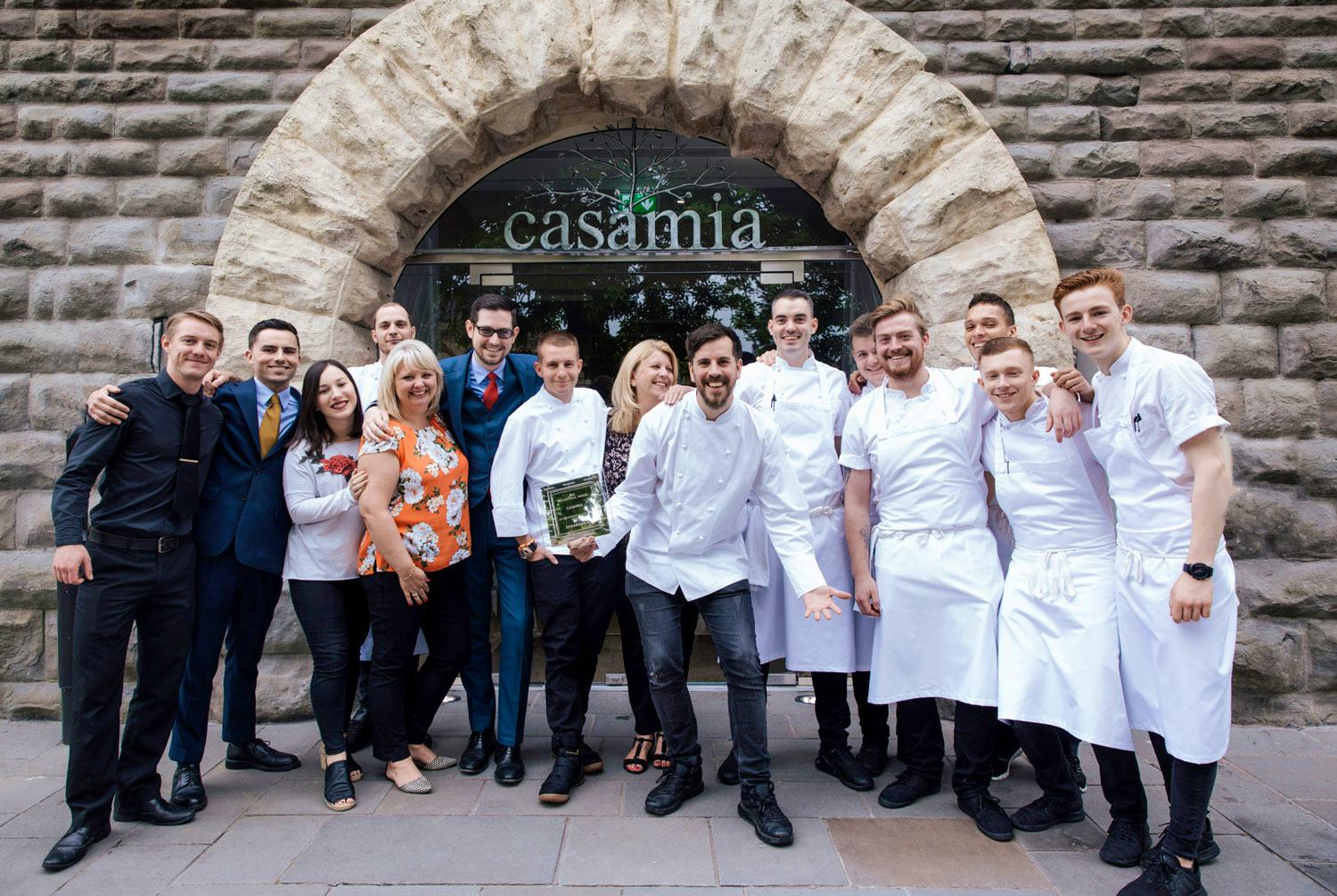 Casamia Bristol Peter Sanchez Iglesias with team outside restaurant with award